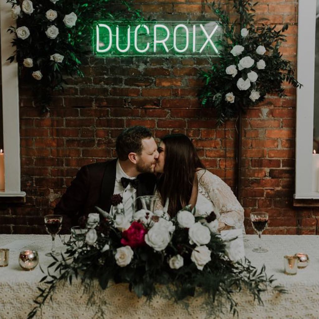 green neon sign for wedding that says &quot;Ducroix&quot;